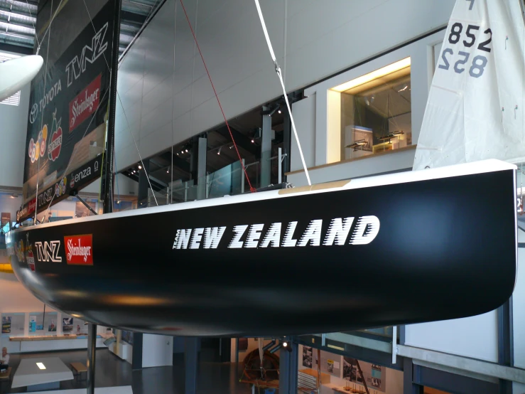 a boat is in an exhibit with a sign hanging from the ceiling