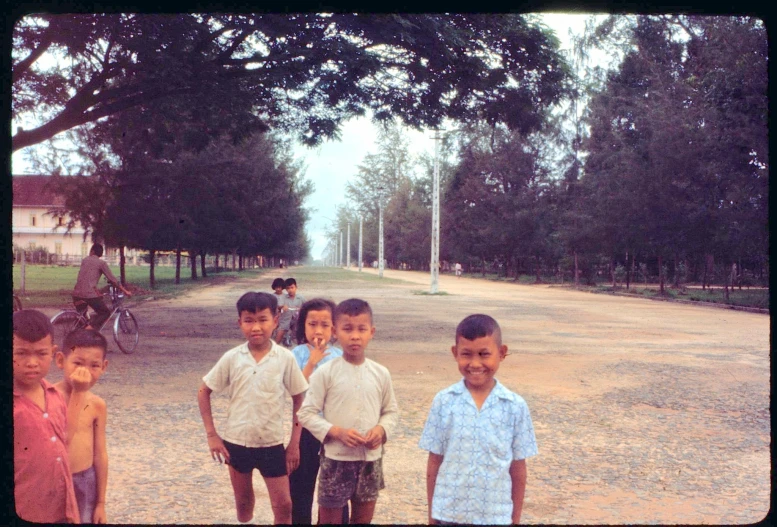 a group of young children in shirts posing for the camera