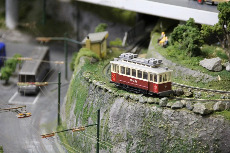 a toy model train sitting on a miniature train track