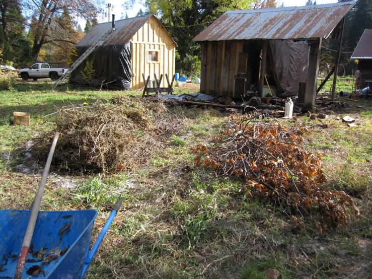 a yard has some hay and wood in it