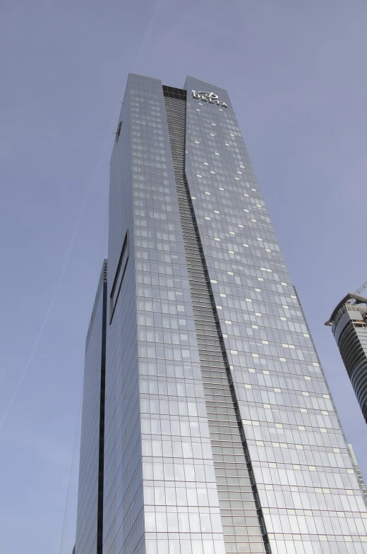 very large glass building in front of a clear blue sky