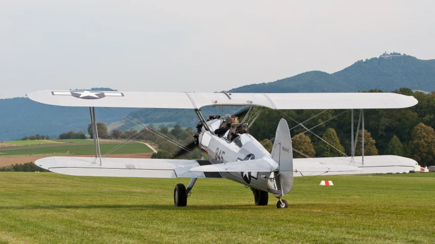 a small airplane parked on top of a lush green field