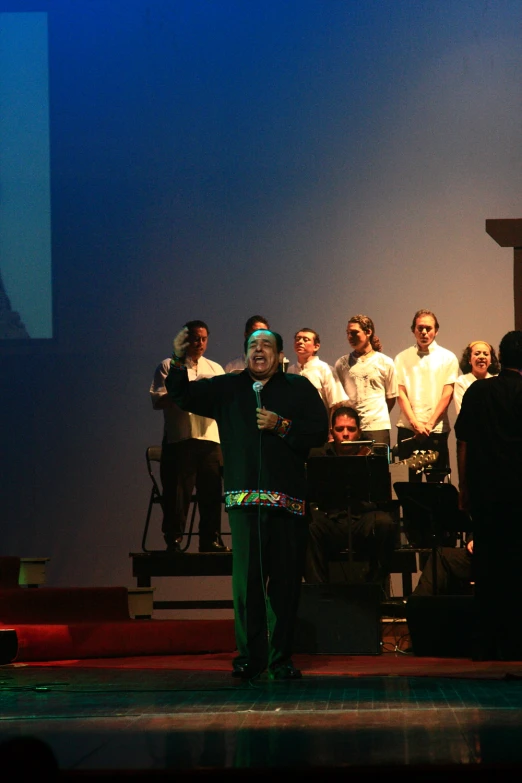 a man in a suit and tie standing on stage