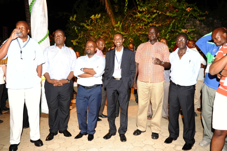 a group of men are standing and talking