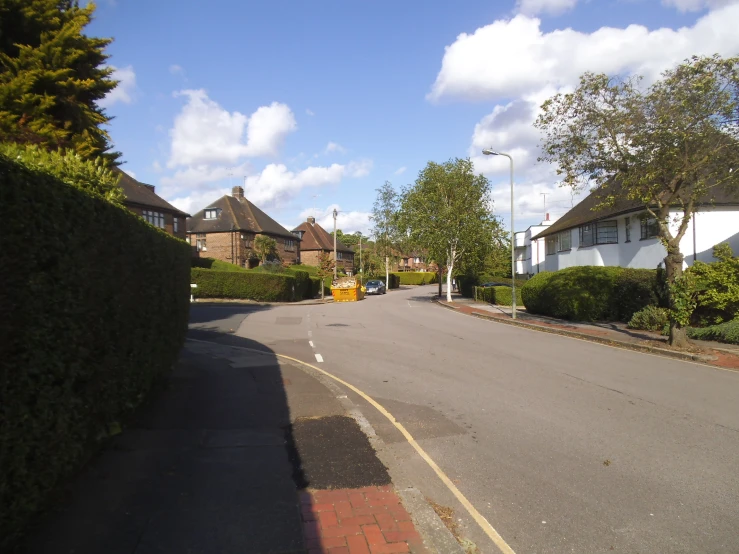 a street in the suburbs with houses lining the sides of it