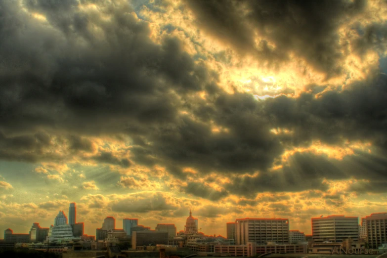 a cloudy skyline with buildings and buildings in the background