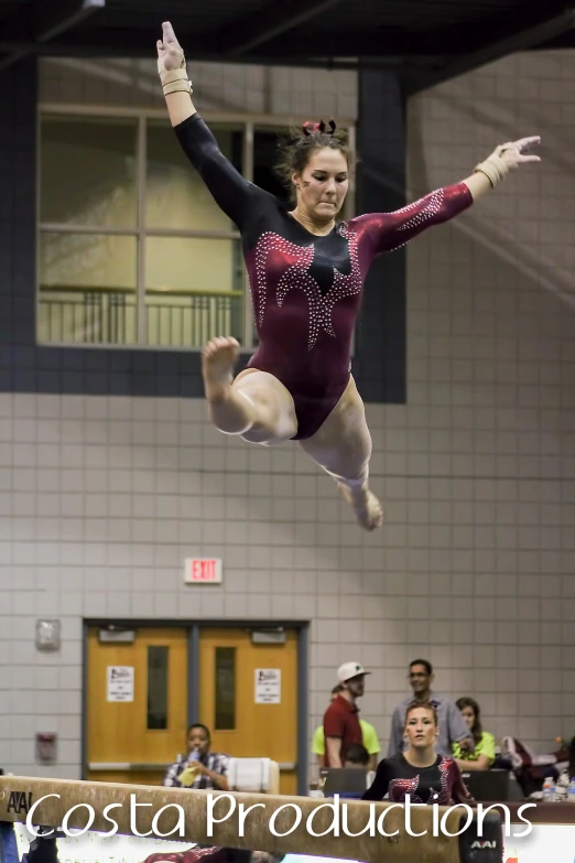 a young woman doing an air leap while standing on one leg