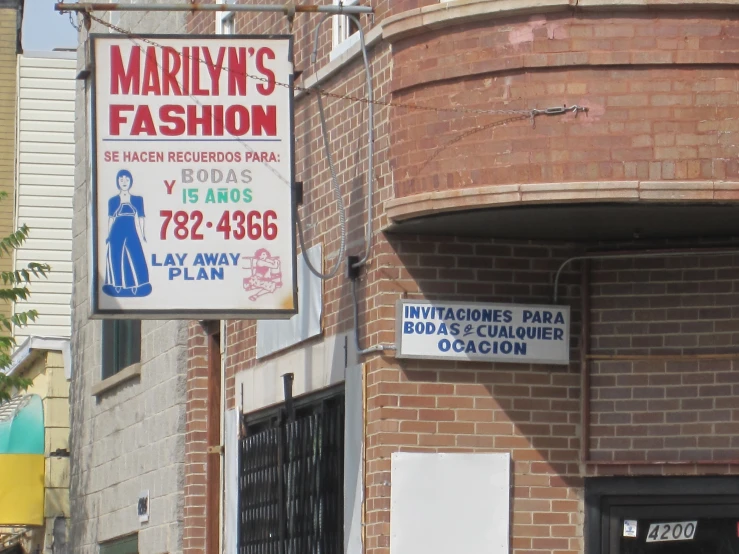 a sign for a fashion store on the street