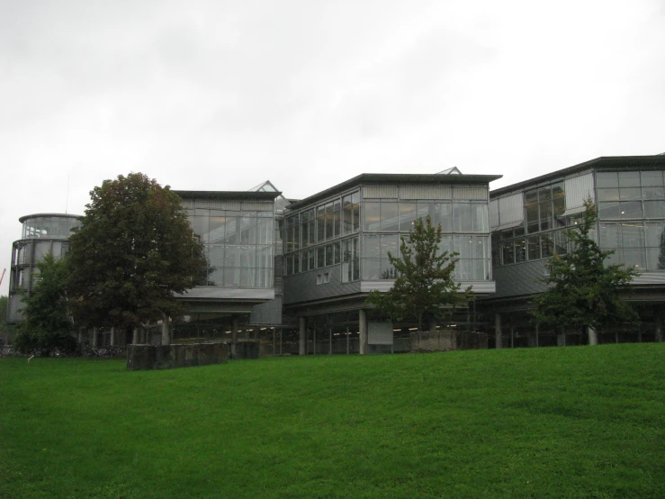 a building on a hill with trees in the foreground