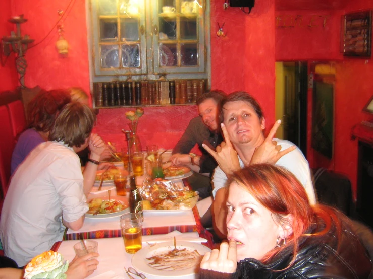 a group of people sitting around a long table eating