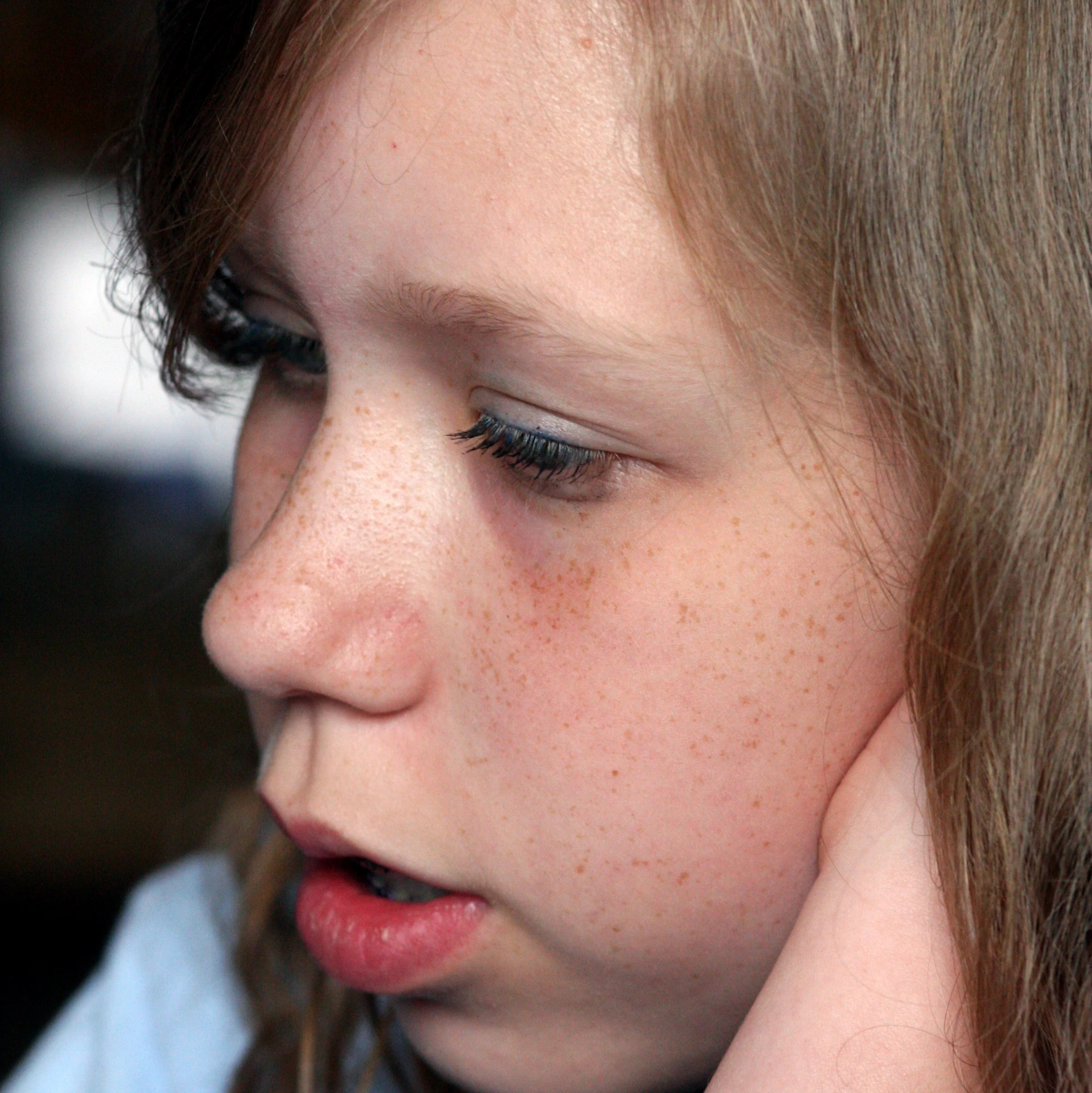 a closeup of a small girl with frecky hair