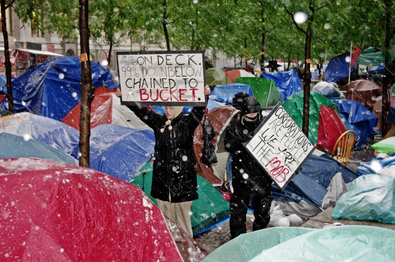 two people holding up signs during a demonstration