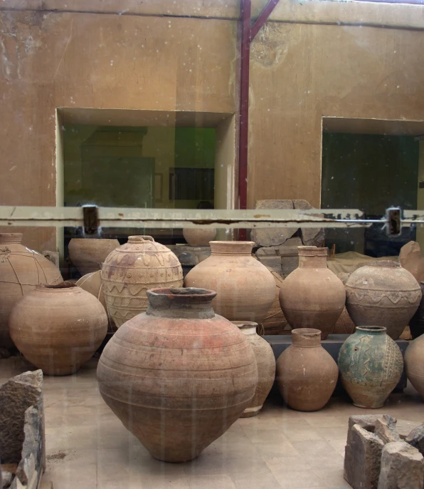 several old vases are on the ground in an old shop