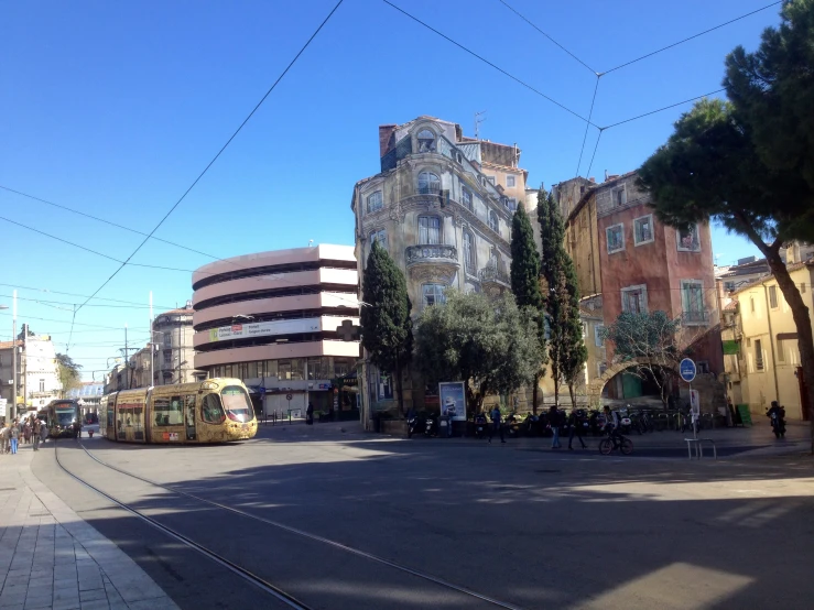 some buses parked next to a building in the street