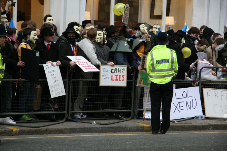 a group of people with masks are lined up behind a gate