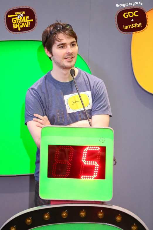 a man standing next to a sign with a clock on it