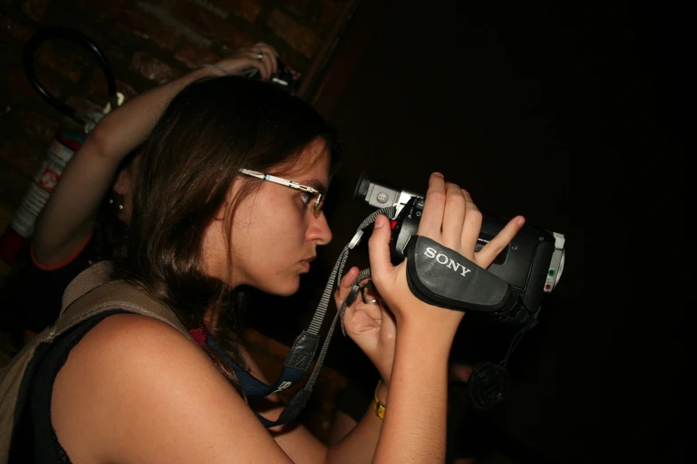 a girl taking pictures with her camera and glasses