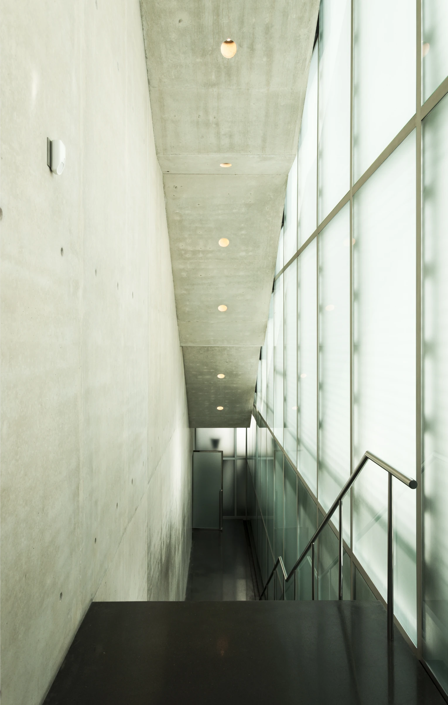 a view of a hallway with the lights on