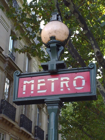 a sign is posted on a green pole outside