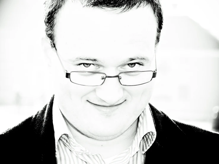 a black and white po of a person wearing glasses