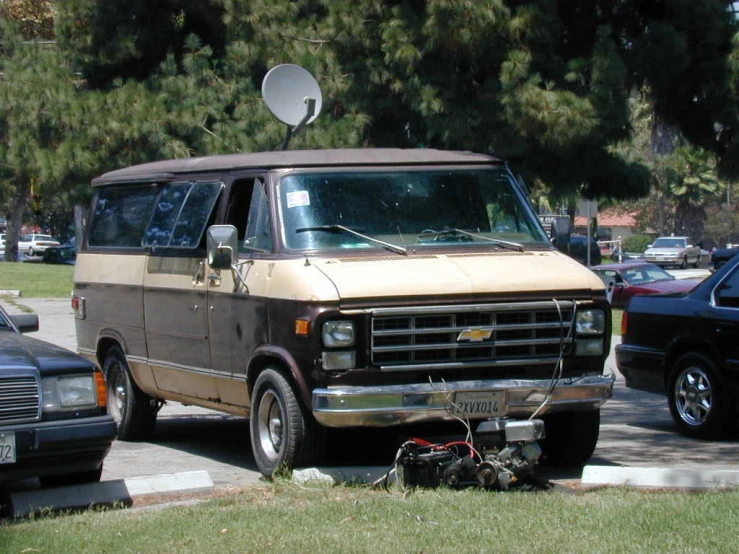 an old style van in parking lot next to trees