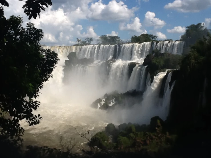 a large waterfall with water spray on it