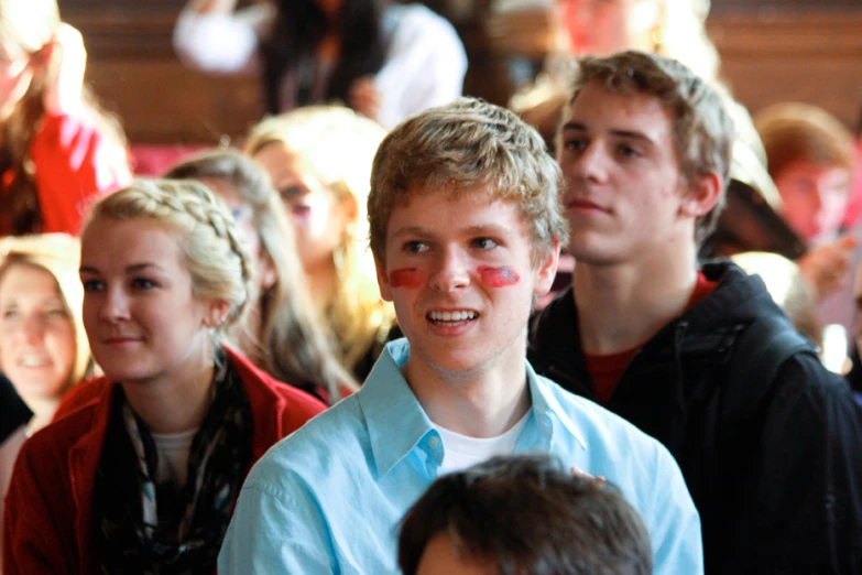 boy with red paint on his face and some other children