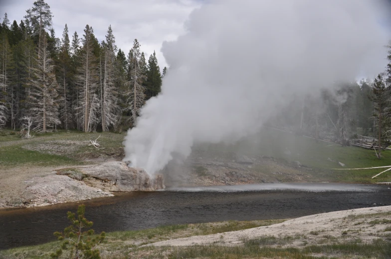 a water pool being spewed from the side of a hill