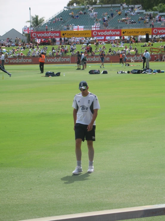 a guy stands on the sidelines at an event