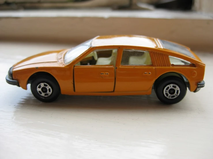 an orange car that is on a table