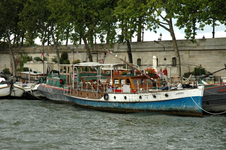 several boats sit along the water in a marina