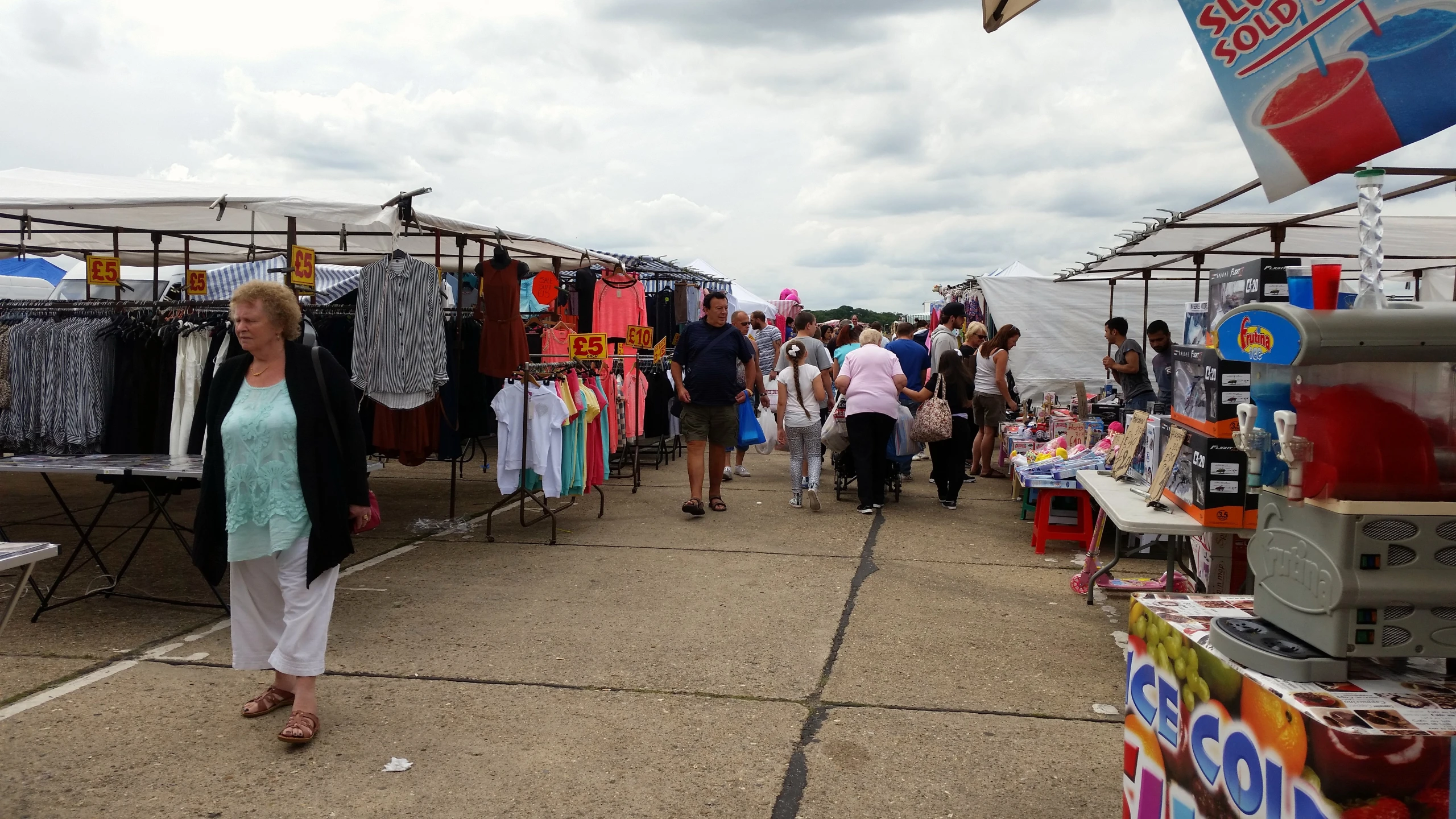 a market has clothes and t - shirts on display