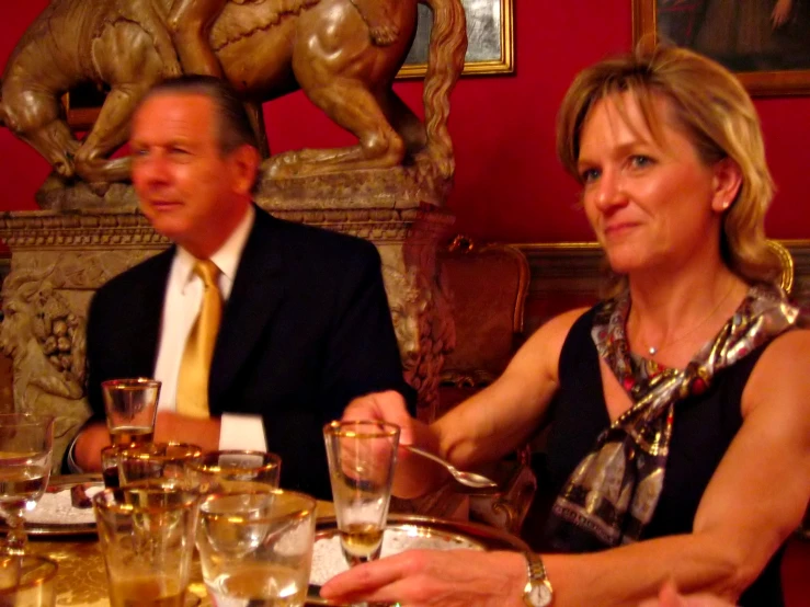 an older man and woman sitting at a dinner table