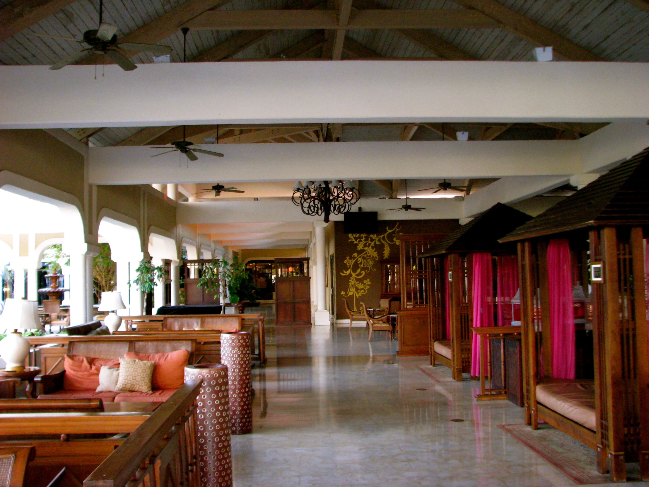 a long hallway with chairs and tables in it