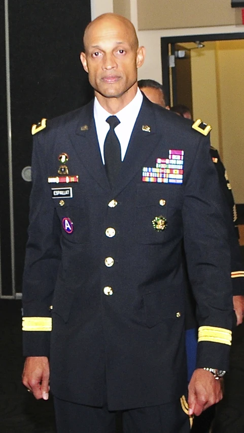 a man in a military uniform stands in the doorway