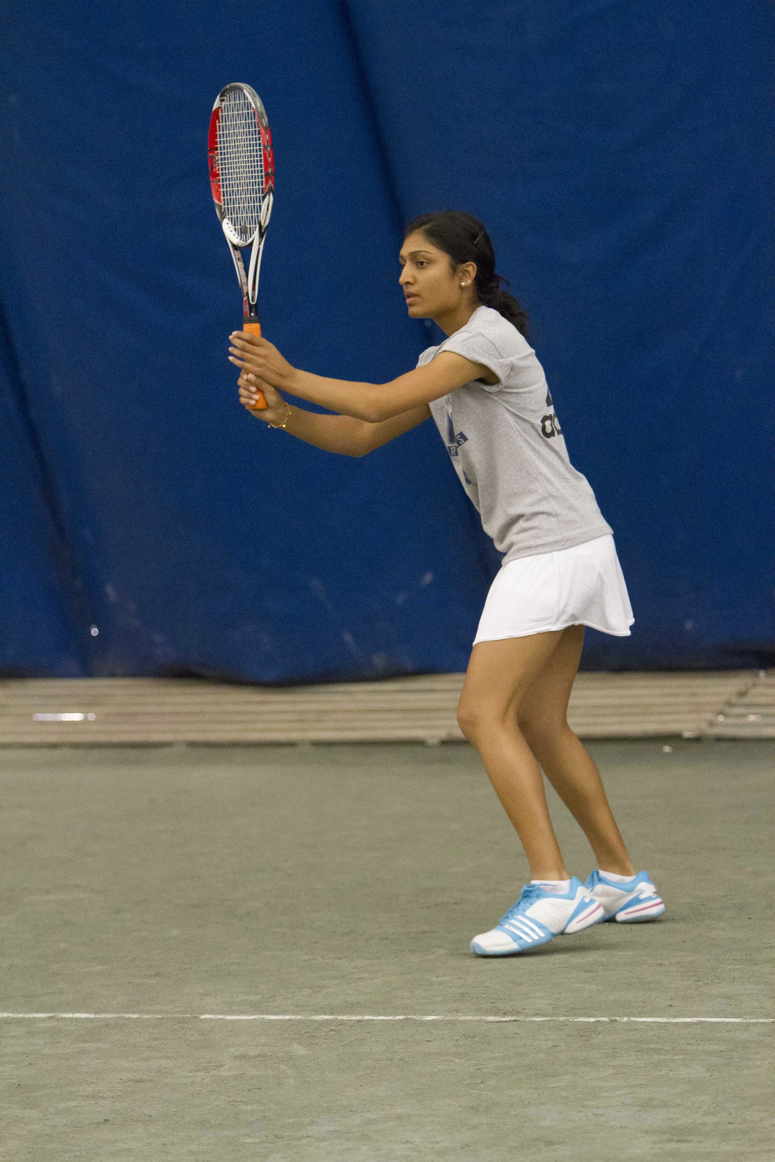 a woman is playing tennis on the court