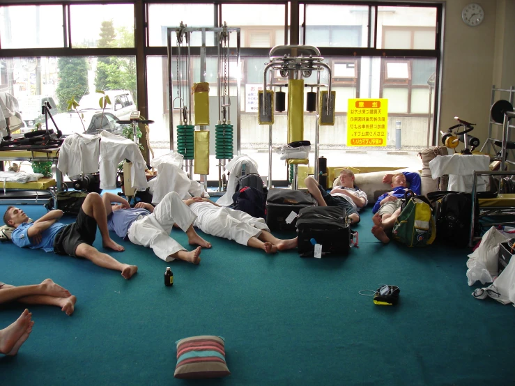 a group of people sit on the floor while all rest