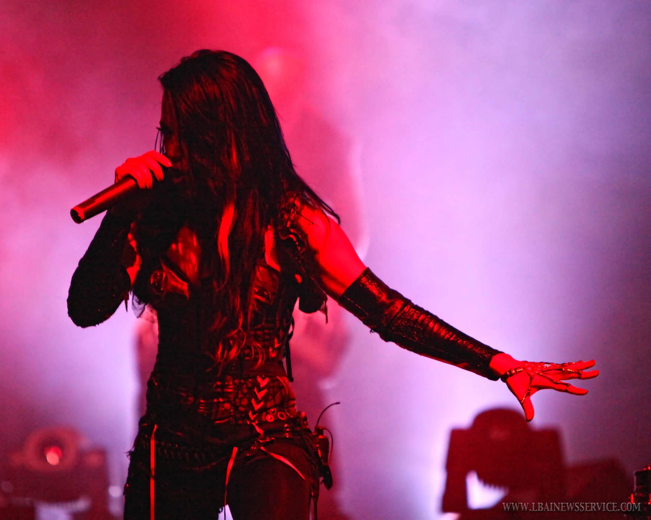 a singer on stage with lights behind her