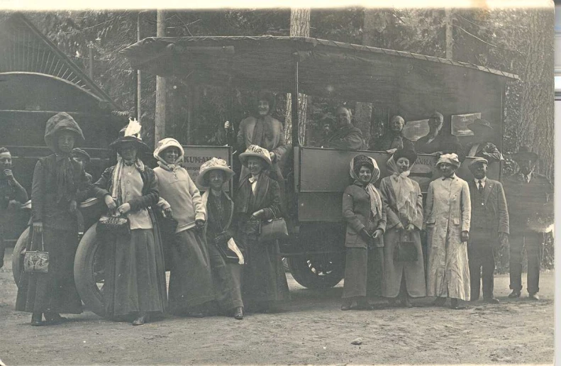 people are posing for a picture in front of an old truck