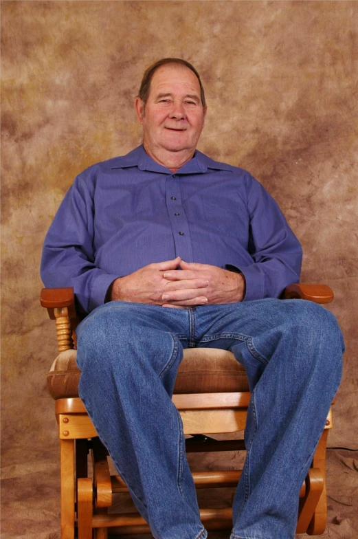 a man sitting in a chair with his feet crossed