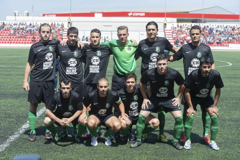 a team poses for a picture before the match