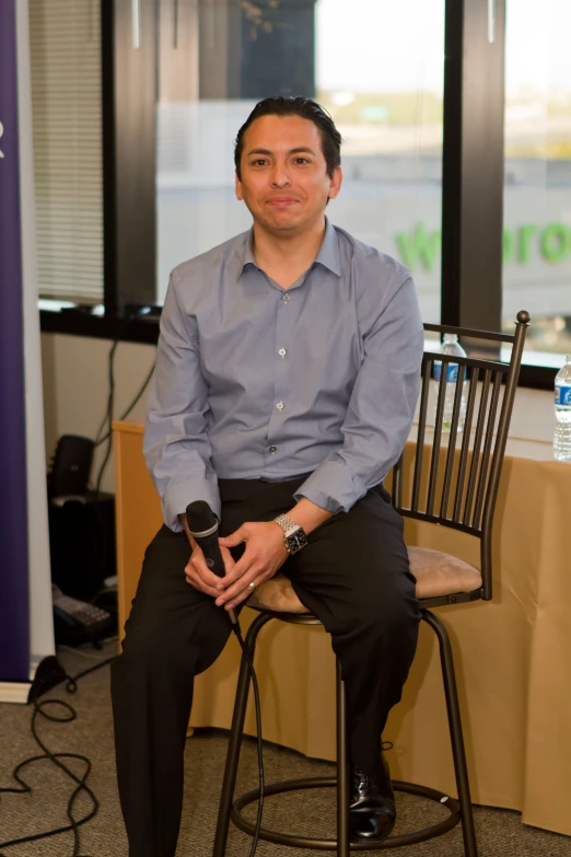 a man sitting on a chair in a room with other signs