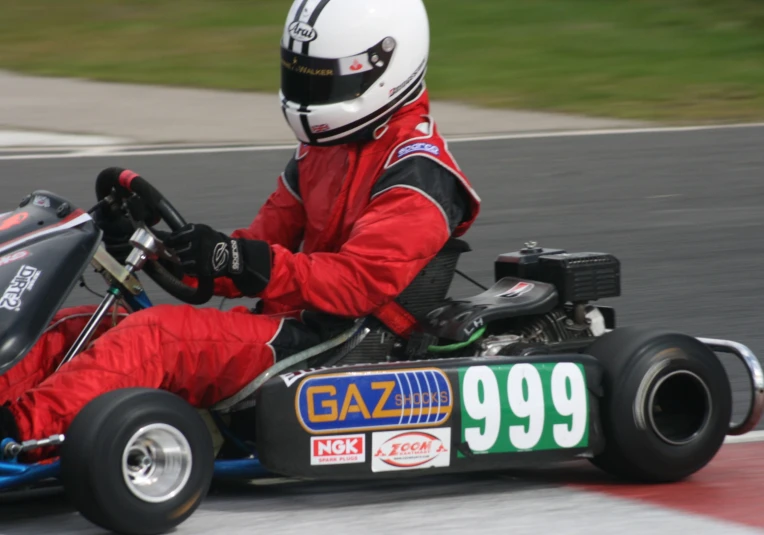 a person in a go kart race driving around a track