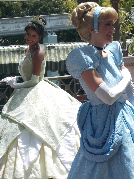 two young women dressed in costumes and one has a hand bag