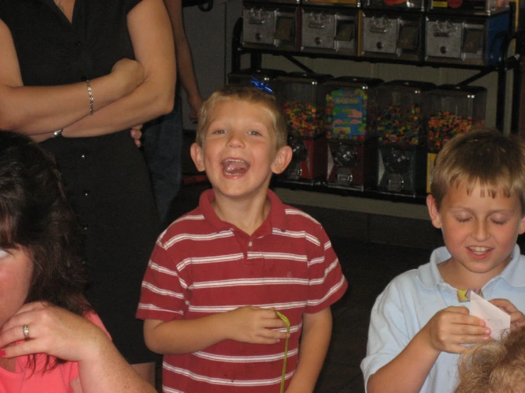 two children smile as people look on