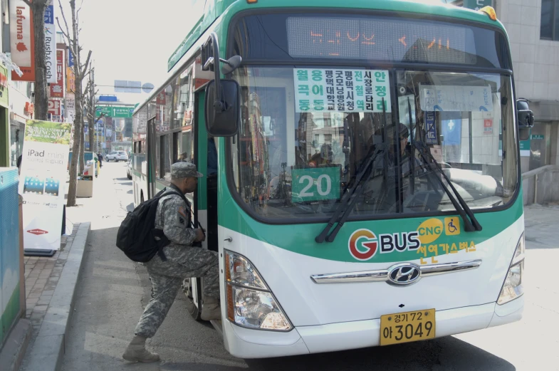 the man is standing at the bus stop