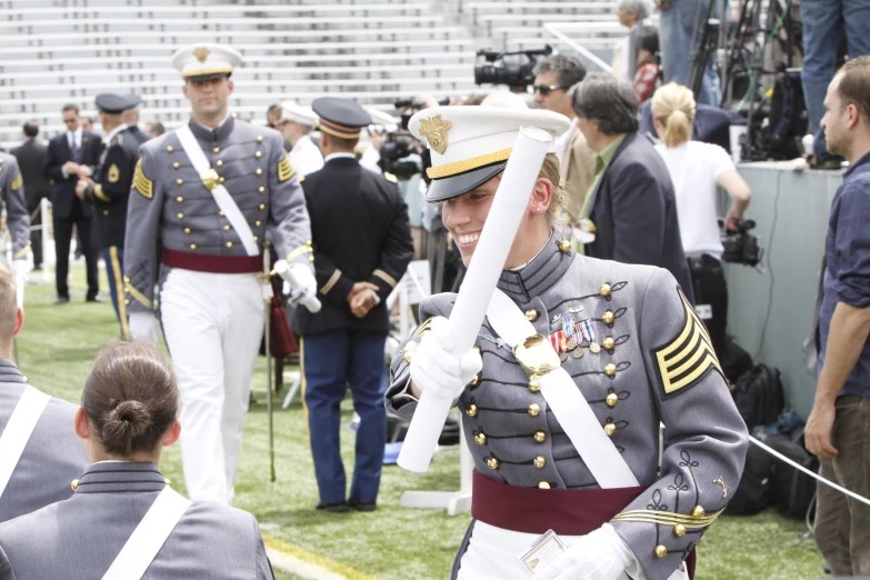 there are men in uniform marching down the field