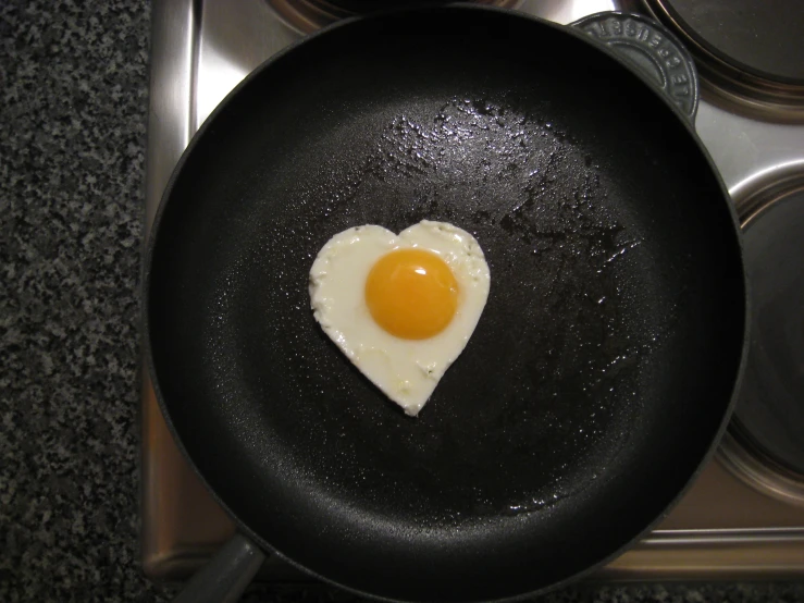 a black set with an egg and fried egg in it