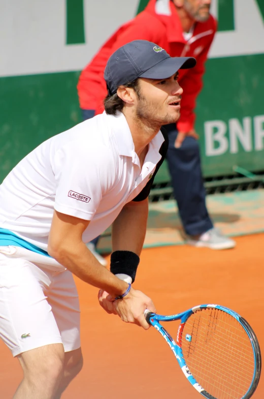 a tennis player on the court holding his racket