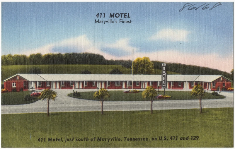 an early postcard of the motel with a green yard